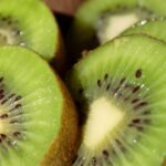 Fresh sliced green kiwifruit – highlighting the natural nutrients and approved EU health benefits of Greek kiwi production.