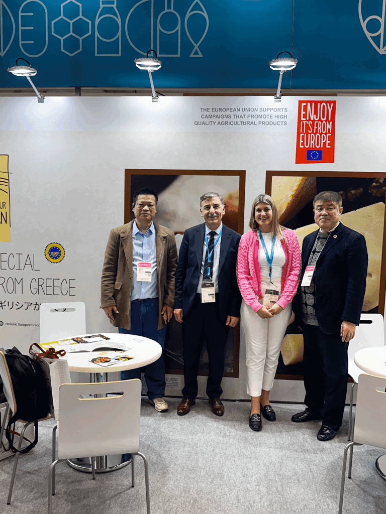 Delegates standing at the EU promotional stand during Foodex Japan 2025, showcasing Greek agricultural products.
