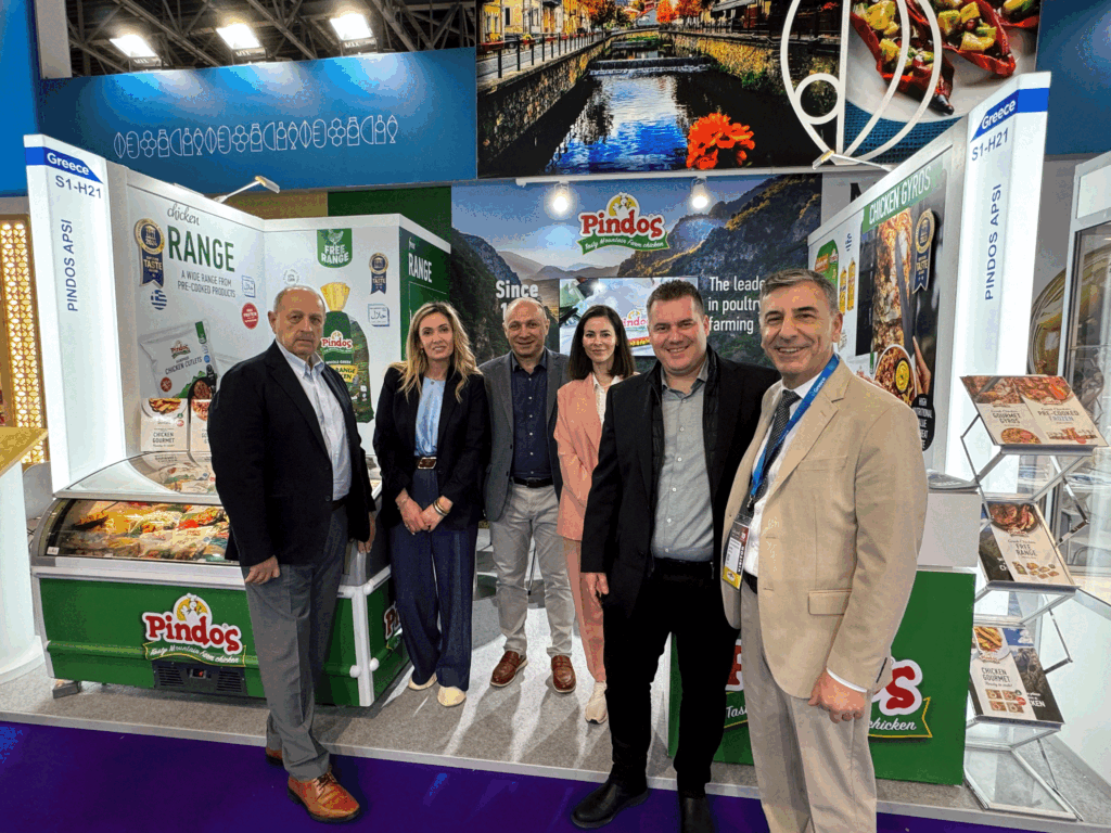 People at the Pindos booth during Gulfood Dubai, showcasing Greek poultry products.