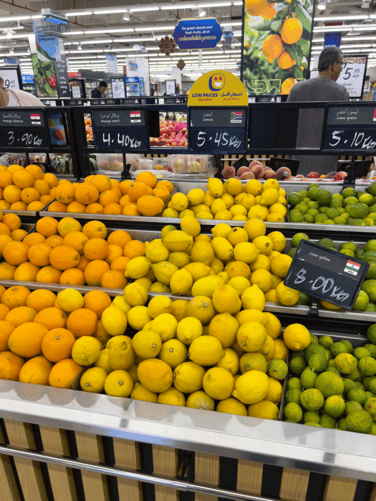 Fresh lemon and lime display at Carrefour UAE during market visit in Dubai.
