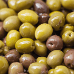 Close-up of mixed Mediterranean olive varieties — symbolising the diversity and authenticity of single-variety olive oils.